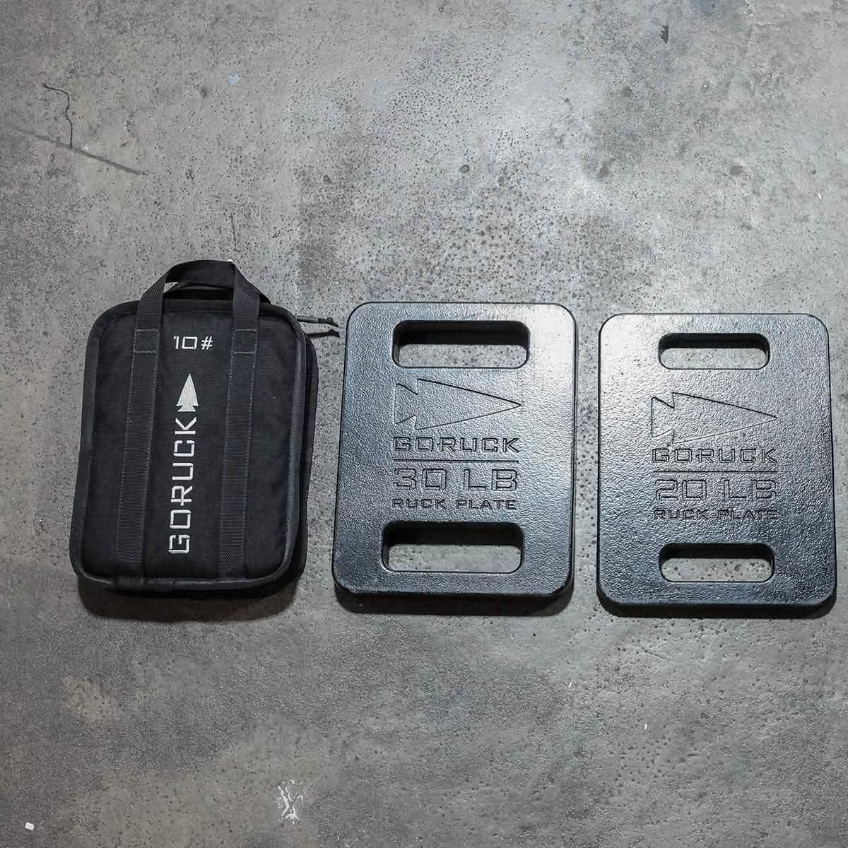 GORUCK 10lb ruck sandbag and 20lb, 30lb ruck plates on concrete floor