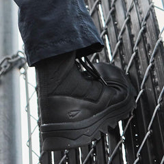 GORUCK black rucking boot on person climbing a metal fence, durable outdoor gear
