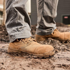 GORUCK tough tan rucking boots on muddy ground, durable footwear for outdoor training