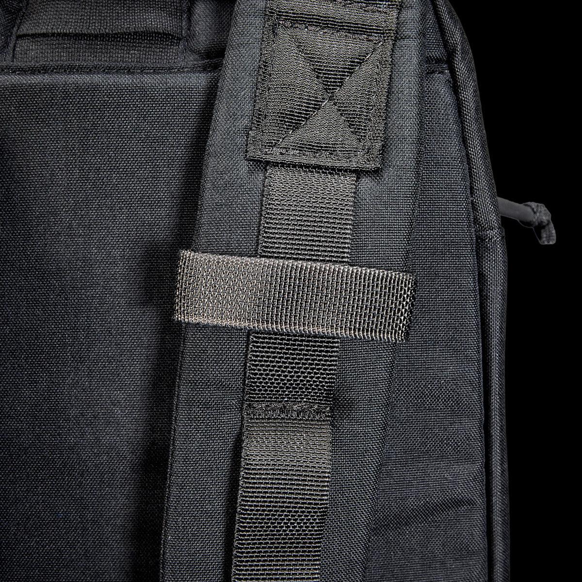 Close-up of GORUCK black rucksack shoulder strap with heavy-duty stitching and MOLLE webbing