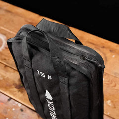 GORUCK 15lb black ruck weight on wooden floor, durable handles, tactical fitness gear