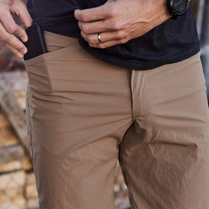 GORUCK durable tan rucking pants with phone in pocket, close-up outdoor shot