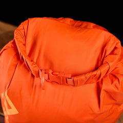 Bright orange GORUCK dry bag with roll-top closure and secure buckle for outdoor rucking gear