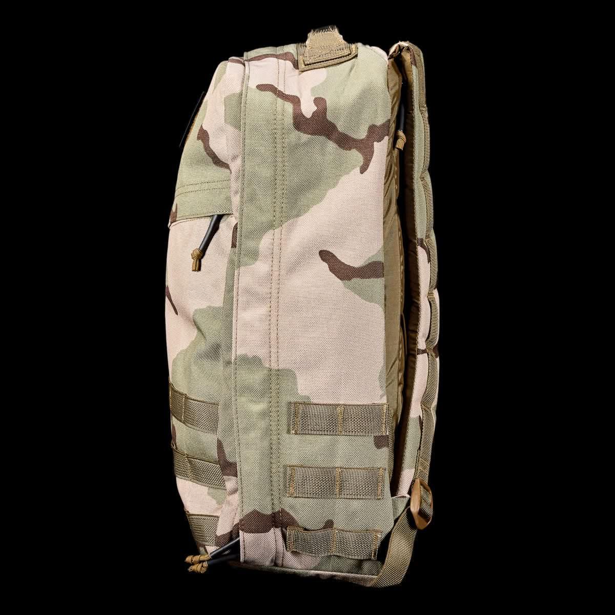 GORUCK camouflage rucksack side view, heavy-duty tactical backpack on black background