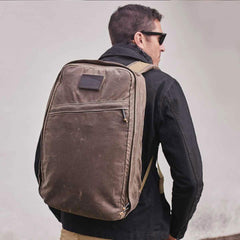Man wearing a GORUCK dark oak rucksack outdoors, showcasing durable rucking gear.