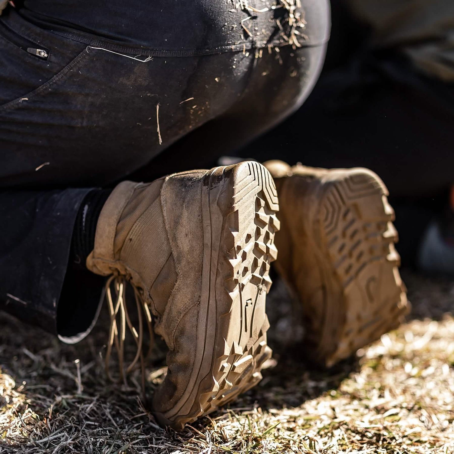 Close-up of GORUCK rugged boots in use outdoors, showing dirt and durable tread design