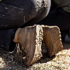 Close-up of GORUCK rugged boots in use outdoors, showing dirt and durable tread design