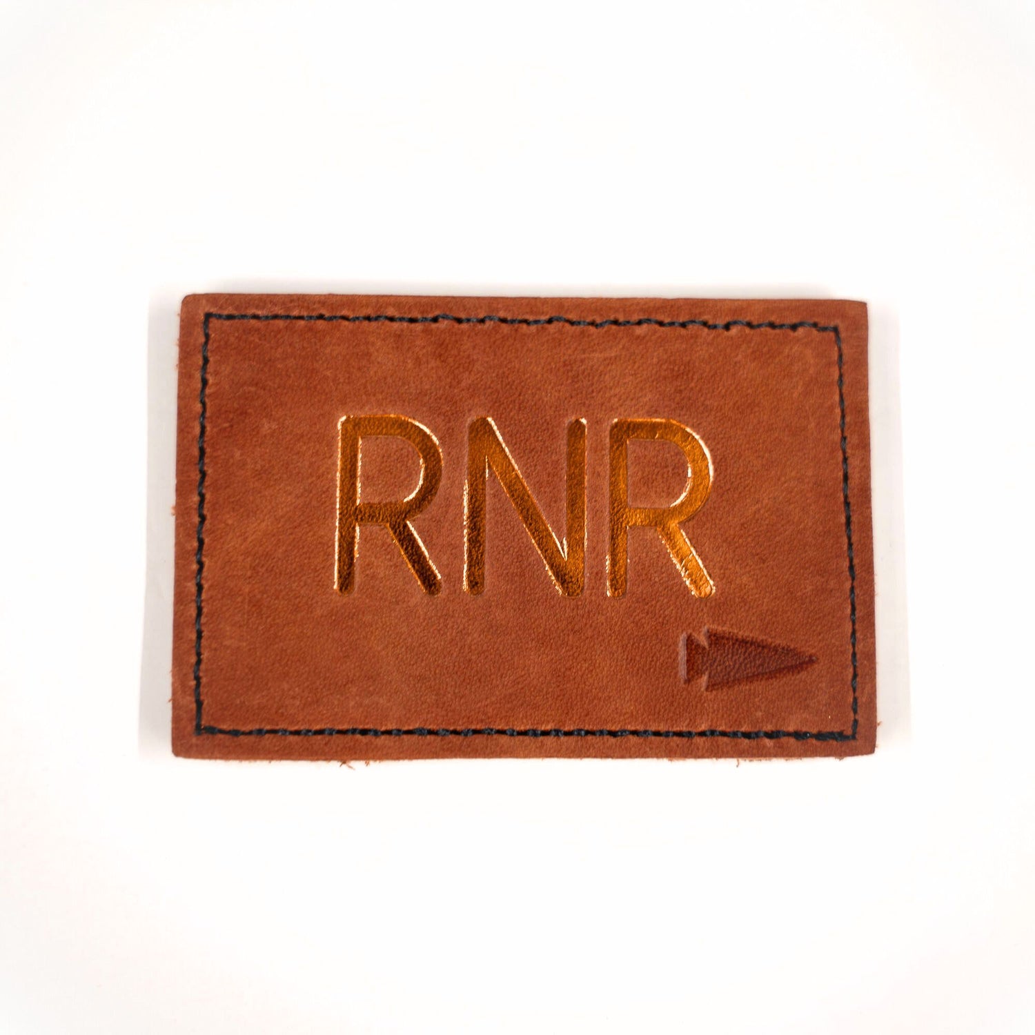 A brown Patch - Custom Leather Monogram featuring 