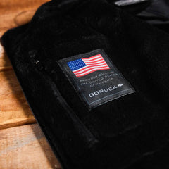 GORUCK jacket interior label with American flag, made in USA, on wooden surface
