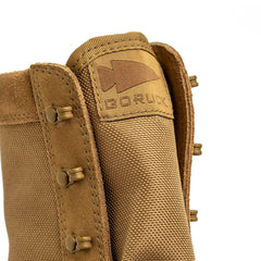 GORUCK rucking boot tongue close-up, durable brown fabric with logo and rugged eyelets