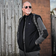 Older man wearing GORUCK rucking gear, black vest, and backpack outdoors
