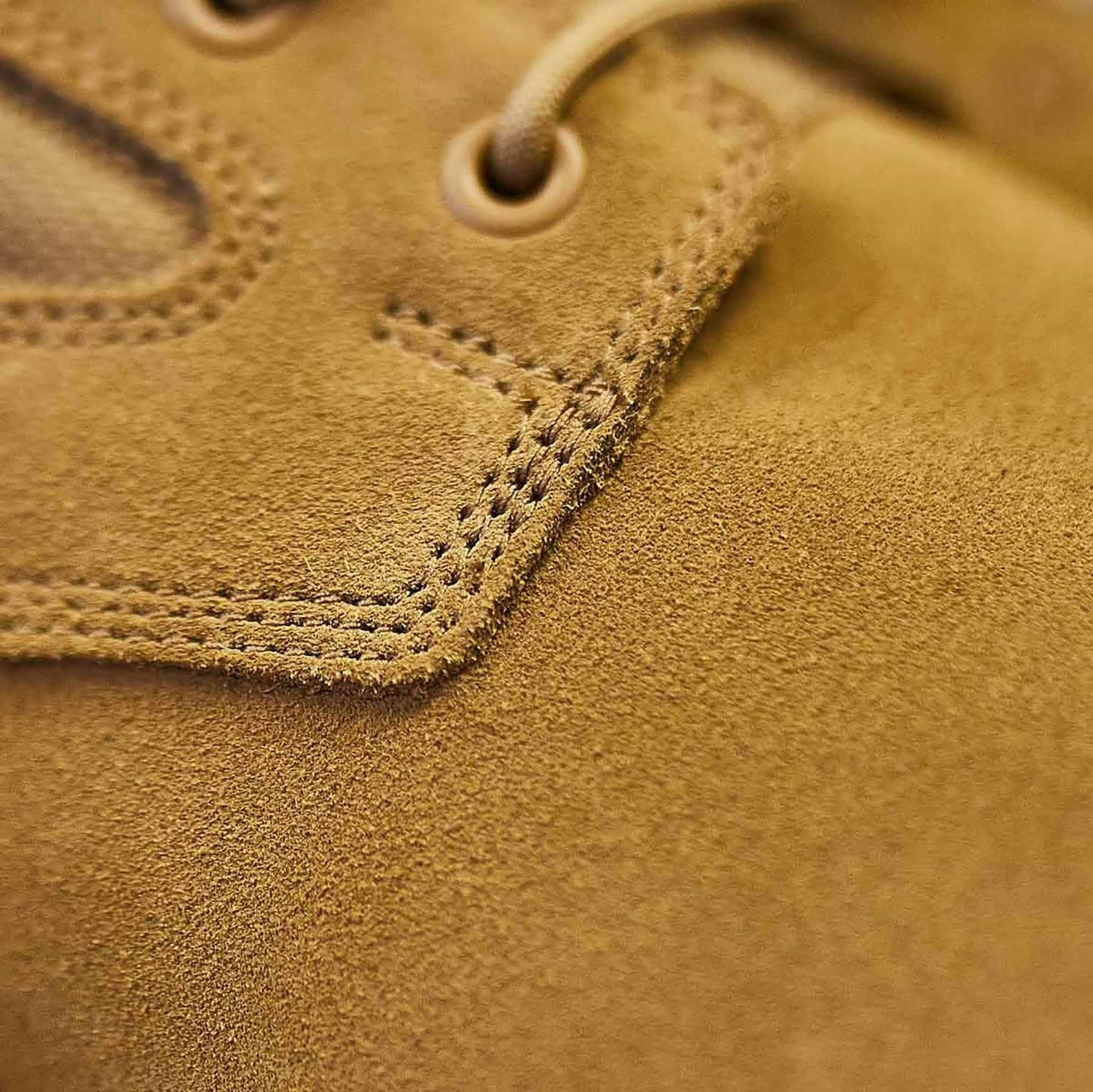 Close-up of rugged tan suede GORUCK rucking boot with detailed stitching and lace eyelet.