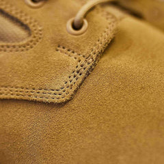 Close-up of rugged tan suede GORUCK rucking boot with detailed stitching and lace eyelet.