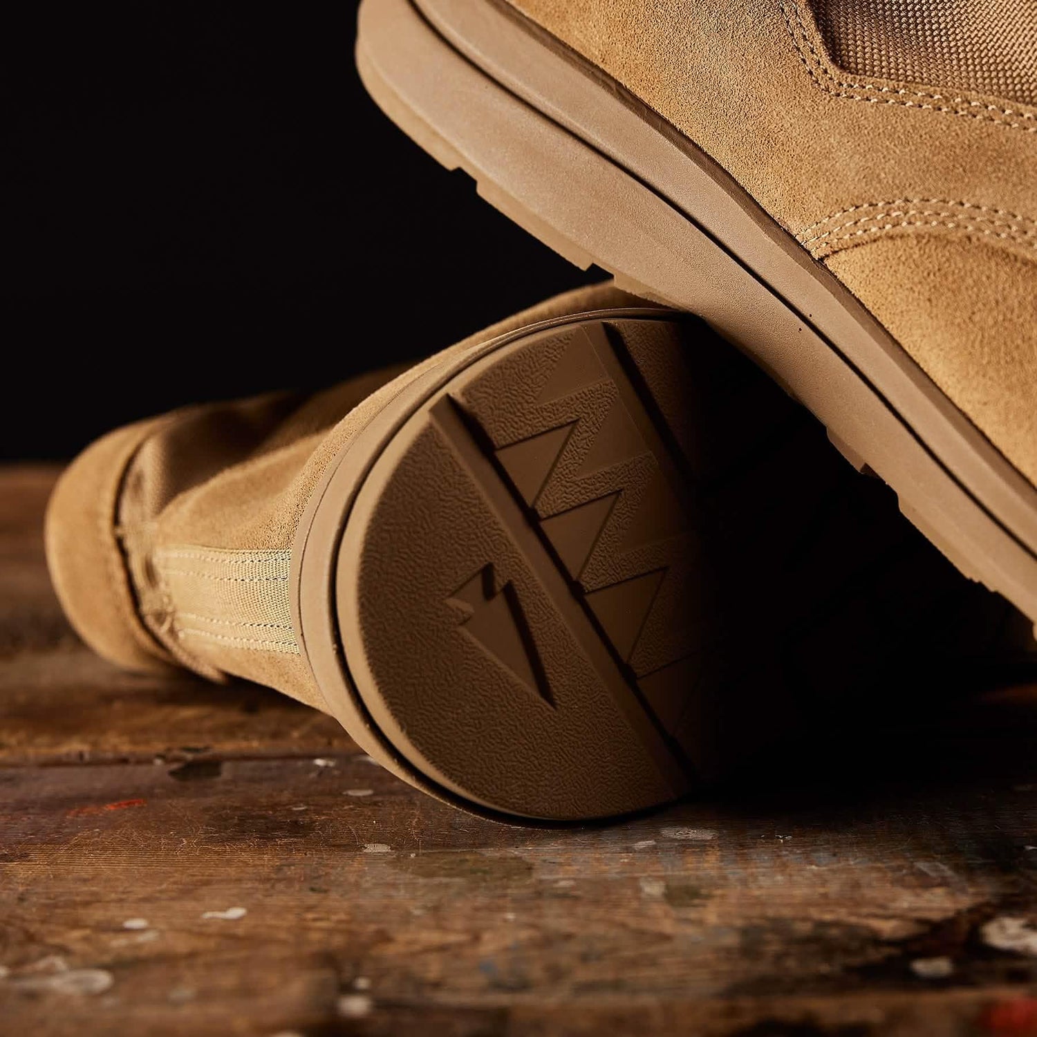 GORUCK tan rucking boot with rugged sole on wooden surface, close-up