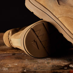 GORUCK tan rucking boot with rugged sole on wooden surface, close-up