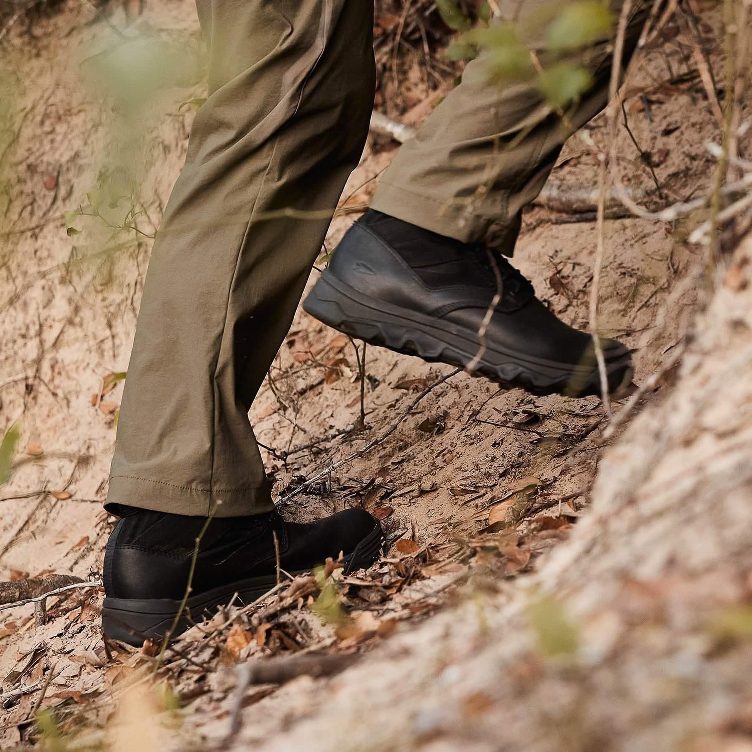 GORUCK rucking boots on person hiking up a dirt trail, outdoor gear close-up