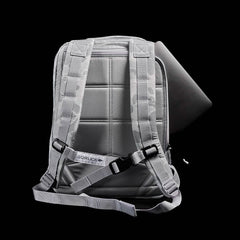 The GR0 - Ripstop ROBIC® is a gray, water-resistant backpack with padded straps and a laptop partially tucked into its back compartment—ideal for minimalist everyday carry.