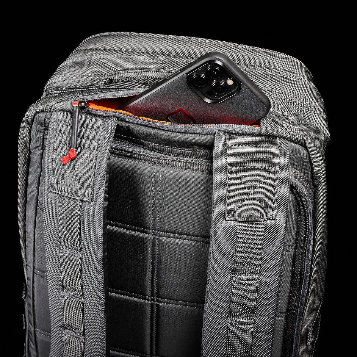 GORUCK grey rucksack with padded straps and phone in hidden back pocket, black background