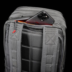 GORUCK grey rucksack with padded straps and phone in hidden back pocket, black background