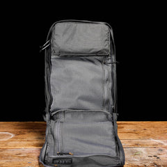 GORUCK Armor Grey rucksack open on wood table, showing mesh compartments and rugged design
