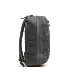 Side view of the Double Compartment Bullet Ruck - Heritage Waxed Canvas - 18L in gray, featuring two main zippered compartments and padded shoulder straps—perfect for use as a travel daypack.