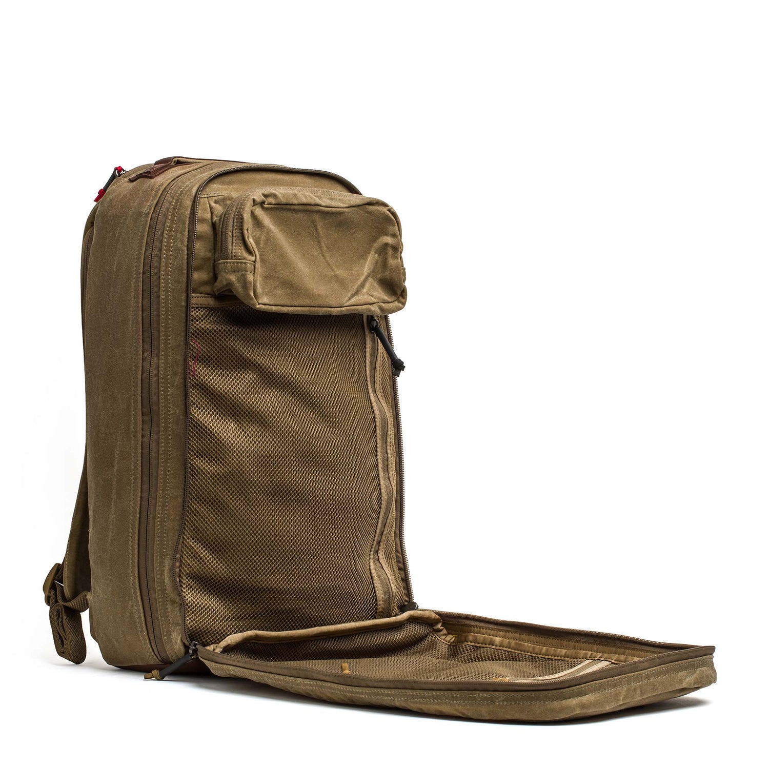The Double Compartment Bullet Ruck—Heritage Waxed Canvas 18L backpack features an open brown waxed canvas design with a mesh inner compartment and small front pocket, perfect as a stylish daypack for travel or adventure.