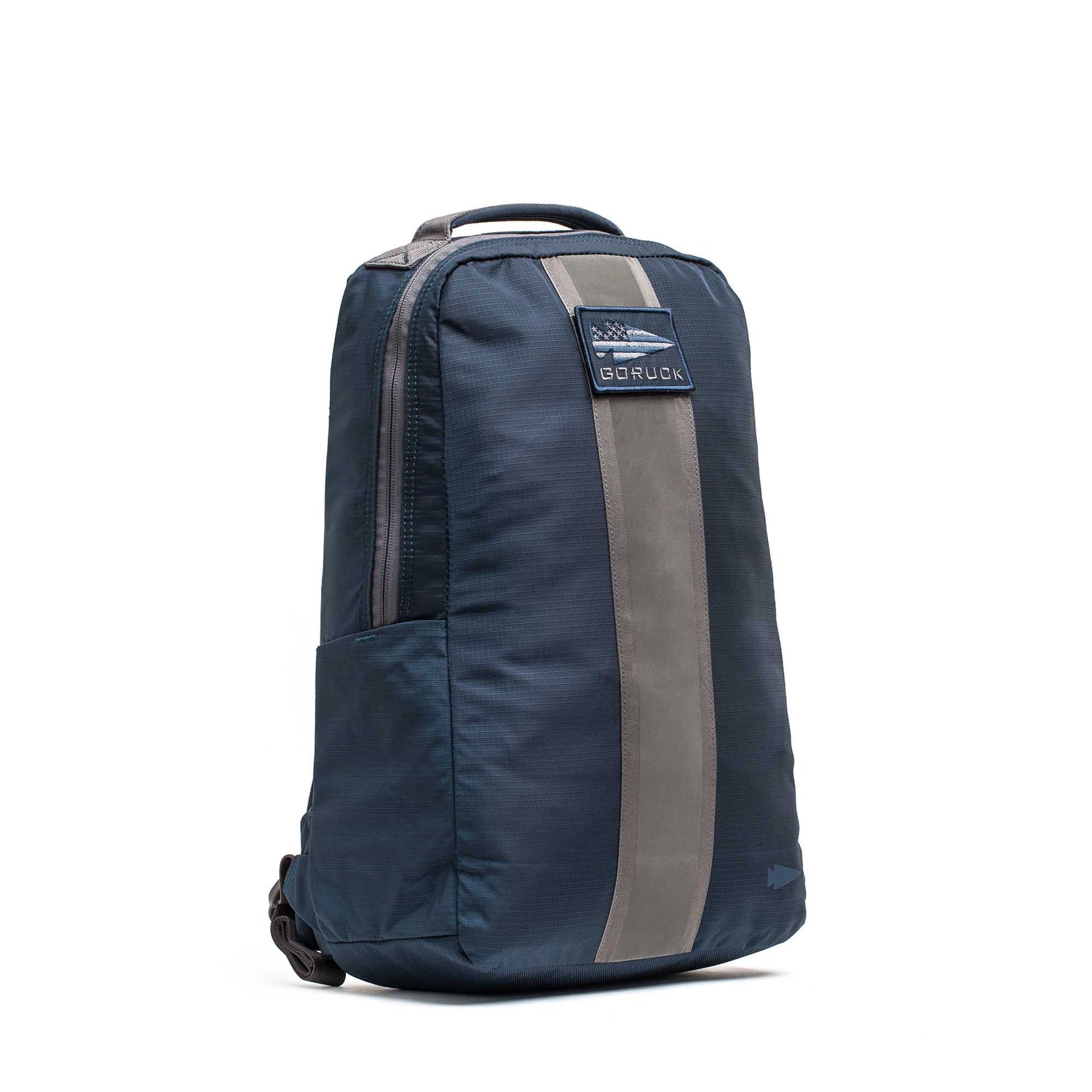 Basic Rucker backpack in dark blue with a gray vertical stripe and top handle, displayed on a white background—ideal for rucking and compatible with a ruck plate.