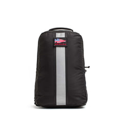 The Basic Rucker, shown in black with a reflective vertical stripe and an American flag patch on the front. Photographed on a white background, it’s designed for rucking and is compatible with a ruck plate.