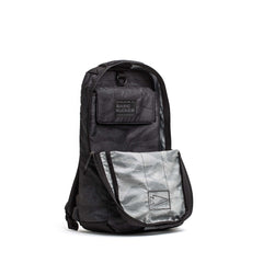 The Basic Rucker is a black and gray camo GORUCK rucking backpack featuring a front pocket and a "BASIC RUCKER" patch on the top flap.