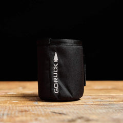 GORUCK black tactical beer jacket koozie on wooden surface, rucking gear accessory