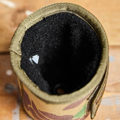 GORUCK camo beer jacket with rugged Velcro interior on wood surface