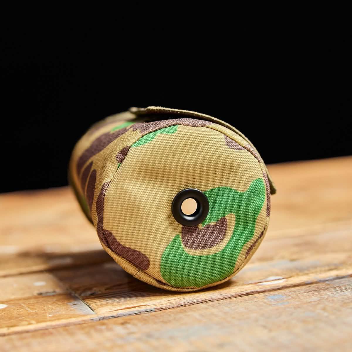 GORUCK camo beer jacket on wood table, durable rucking gear accessory