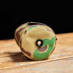 GORUCK camo beer jacket on wood table, durable rucking gear accessory