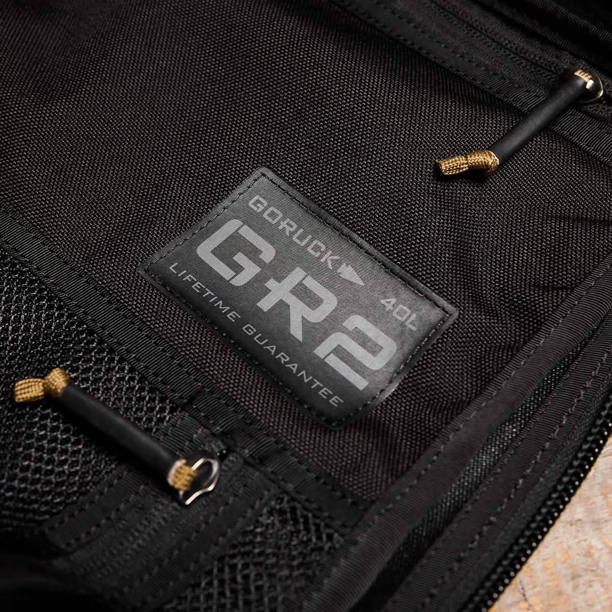 Close-up of GORUCK GR2 40L black rucksack with lifetime guarantee label and zippers