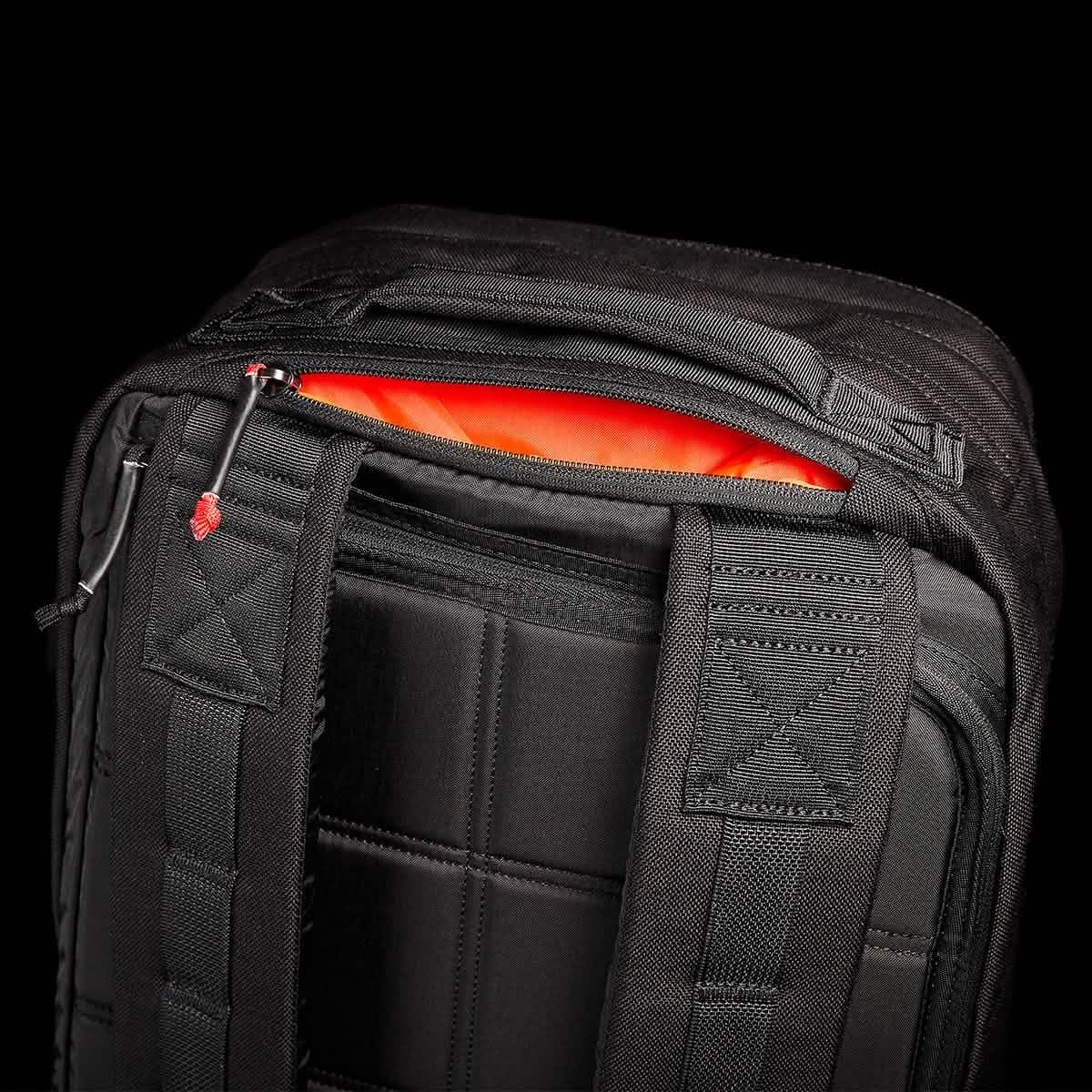 GORUCK black rucksack close-up with padded straps and orange interior, durable rucking backpack