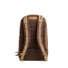 The Double Bullet Ruck w/ Bombproof Laptop Compartment - 18L features tan padded shoulder straps and a brown double compartment design. It's shown from the back on a white background and offers secure laptop storage for travel.