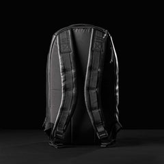 GORUCK Bullet 15L black leather backpack back view with padded straps on black background
