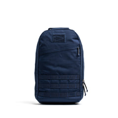 The Bullet Ruck Classic - Ballistic Nylon Cordura is a navy blue 15L daypack with a zippered front pocket and lower front webbing—ideal for everyday adventures.