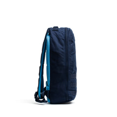 Streamlined Bullet Ruck Classic - Ballistic Nylon Cordura backpack in dark blue with light blue straps, shown upright from the side—ideal as a 15L daypack for daily adventures.