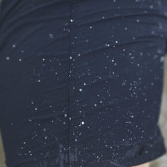 Close-up of GORUCK Challenge Short in navy with water droplets showing water resistance.