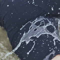 GORUCK water-resistant shorts in use, close-up view with water splashing outdoors