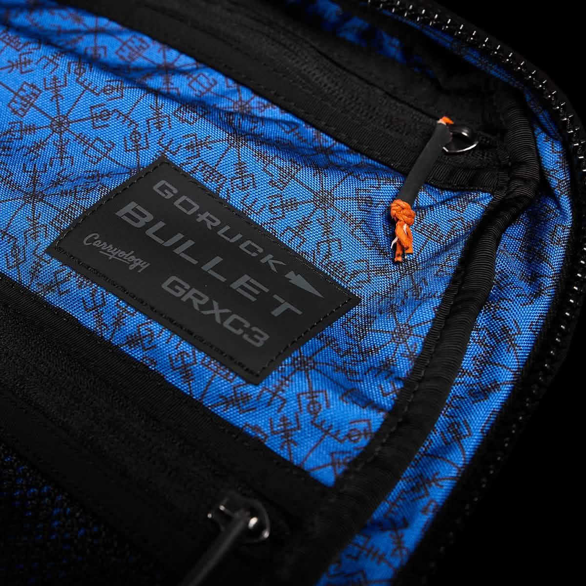 GORUCK Bullet backpack interior showing Carryology GRXC3 patch on blue patterned fabric