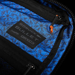 GORUCK Bullet backpack interior showing Carryology GRXC3 patch on blue patterned fabric
