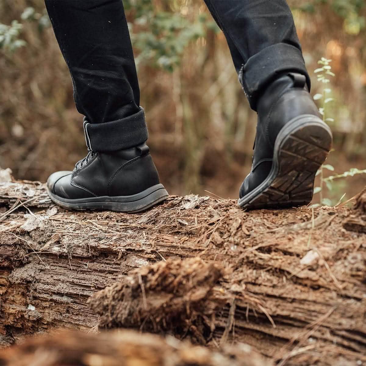 GORUCK black rucking boots on person walking outdoors on a log in the woods