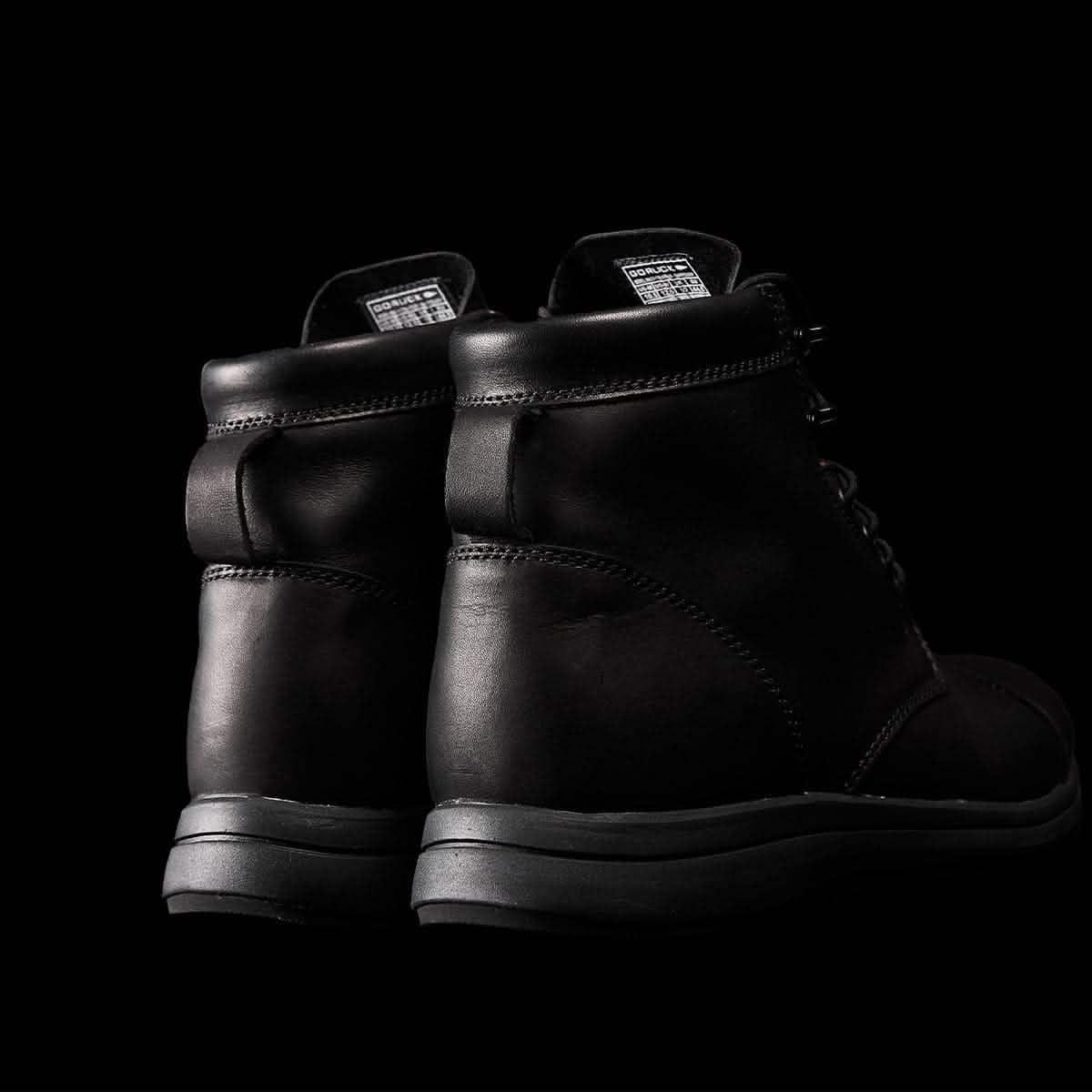 GORUCK black leather rucking boots close-up on black background