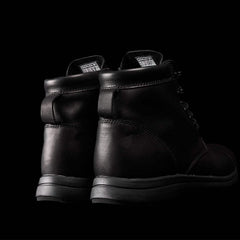 GORUCK black leather rucking boots close-up on black background
