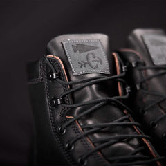 Close-up of black GORUCK rucking boots with logo patch and detailed laces