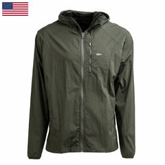 The Indestructible Challenge Windbreaker is an olive green hooded jacket with a front zipper, small logo, and abrasion-resistant ToughDry fabric. Shown on a white background with a US flag in the corner.