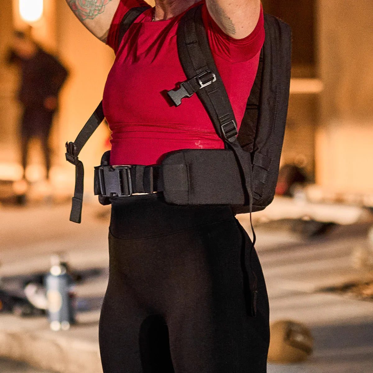 Person wearing GORUCK rucksack with padded hip belt outdoors at sunset