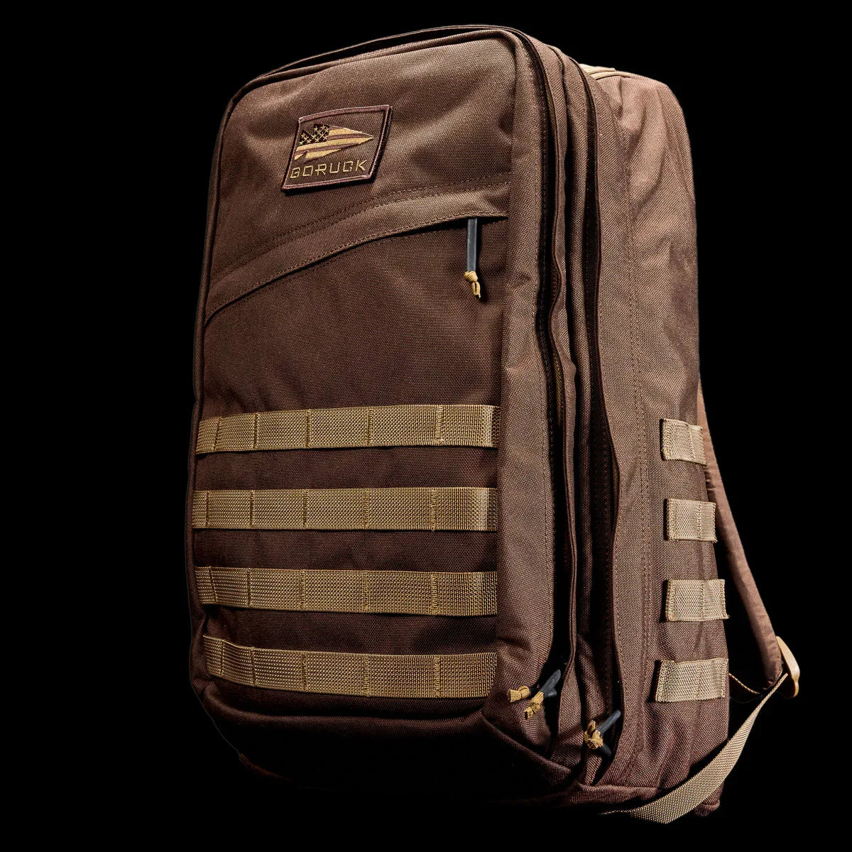GORUCK brown tactical backpack with MOLLE webbing on black background